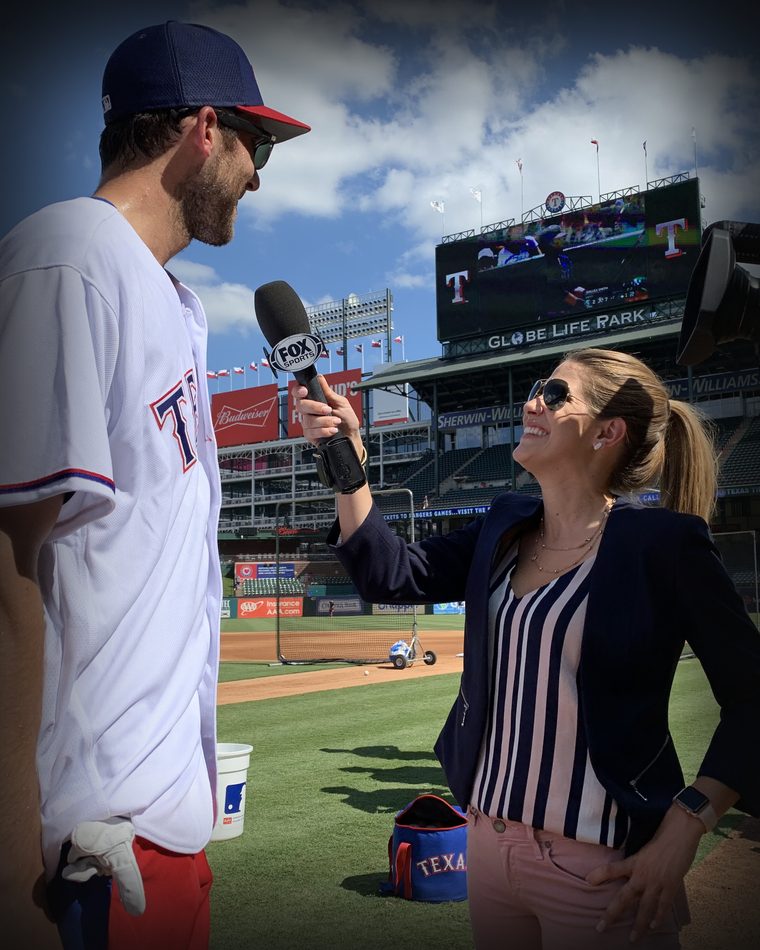 Sarah Merrifield interviewing a Texas Rangers player at Globe Life Park